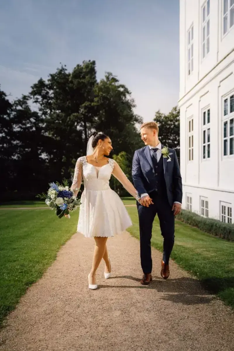 Couple walking hand in hand at Gråsten Palace